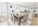 Bright dining room features a wooden table set for six, a chandelier, and a large window at 2408 Adrift Road, Fuquay Varina, NC 27526