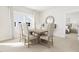 Dining room area with a large window, comfortable seating, and decorative mirror at 2408 Adrift Road, Fuquay Varina, NC 27526