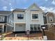 Charming new construction home with a light blue exterior and black framed windows at 2408 Adrift Road, Fuquay Varina, NC 27526