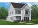 Charming two-story home with light blue siding, black shutters and brick foundation, complemented by a manicured lawn at 2408 Adrift Road, Fuquay Varina, NC 27526