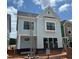New two-story home with light blue siding, black windows, and a dark gray roof under a sunny sky at 2408 Adrift Road, Fuquay Varina, NC 27526