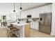 Open-concept kitchen with white cabinets, stainless steel appliances, and a center island with seating at 2408 Adrift Road, Fuquay Varina, NC 27526