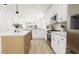 Bright kitchen with white cabinets, a center island, and stainless steel appliances at 2408 Adrift Road, Fuquay Varina, NC 27526