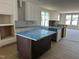 Modern kitchen with white cabinetry, stainless steel appliances, and a functional island at 2408 Adrift Road, Fuquay Varina, NC 27526