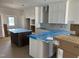 Bright kitchen showcasing white cabinets, an island, and modern finishes at 2408 Adrift Road, Fuquay Varina, NC 27526