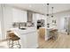 Stylish kitchen boasts white cabinets, stainless steel appliances, and a breakfast bar with seating at 2408 Adrift Road, Fuquay Varina, NC 27526