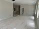 Unfinished living room with white walls and trim, as well as an unfinished staircase in the background at 2408 Adrift Road, Fuquay Varina, NC 27526