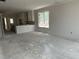 Open-concept living room with ample natural light awaiting flooring and paint at 2408 Adrift Road, Fuquay Varina, NC 27526