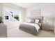 Comfortable main bedroom featuring a decorative headboard, large windows, and side tables at 2408 Adrift Road, Fuquay Varina, NC 27526