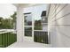 Inviting porch with black railings and screen door provides outdoor living space with a neighborhood view at 2408 Adrift Road, Fuquay Varina, NC 27526