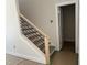 Modern staircase with wood treads and sleek metal railings at 2408 Adrift Road, Fuquay Varina, NC 27526