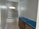 New bathroom features a tub, small window, and a dark wooden vanity ready for finishing touches at 2412 Adrift Road, Fuquay Varina, NC 27526