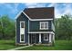 Two-story home with vertical siding, white trim, and a covered front porch at 2412 Adrift Road, Fuquay Varina, NC 27526