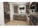 Modern kitchen with stainless steel appliances, a window over the sink, and stylish cabinetry at 2412 Adrift Road, Fuquay Varina, NC 27526