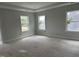 Bright and airy primary bedroom featuring neutral paint, large windows, and tray ceilings ready for personalization at 2412 Adrift Road, Fuquay Varina, NC 27526