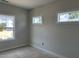 Bright, blank-canvas bedroom with three new windows, awaits your personal touch ready for customization at 2412 Adrift Road, Fuquay Varina, NC 27526