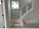 Modern staircase featuring black metal railings, light wood accents, and a large window for natural light at 2412 Adrift Road, Fuquay Varina, NC 27526