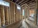 New construction bathroom featuring stud framing, windows, and plumbing at 3301 Dell Dr, Raleigh, NC 27609