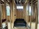Unfinished bathroom framing with a pre-formed shower pan and multiple window openings for natural light at 3301 Dell Dr, Raleigh, NC 27609