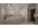 Elegant bathroom with double vanity, gold fixtures, and a large bathtub at 3301 Dell Dr, Raleigh, NC 27609