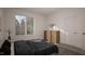 Serene bedroom with dresser and large window at 3301 Dell Dr, Raleigh, NC 27609