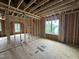 New construction bedroom featuring stud framing, windows, and wood flooring at 3301 Dell Dr, Raleigh, NC 27609