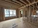 New construction bedroom featuring stud framing, a window, and wood flooring at 3301 Dell Dr, Raleigh, NC 27609