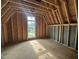New construction bedroom featuring stud framing, a window, and wood flooring at 3301 Dell Dr, Raleigh, NC 27609