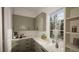 Butler's pantry with green cabinets, marble countertops, and coffee bar at 3301 Dell Dr, Raleigh, NC 27609