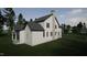 Architectural rendering of a modern farmhouse-style home with white siding and a stone chimney at 3301 Dell Dr, Raleigh, NC 27609