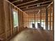 A new construction garage with wooden framing and a view to the outside at 3301 Dell Dr, Raleigh, NC 27609