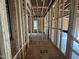 Unfinished hallway with exposed studs showing layout with views to the other rooms at 3301 Dell Dr, Raleigh, NC 27609