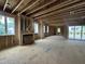 Large unfinished living room framing with fireplace, natural light, and sliding doors at 3301 Dell Dr, Raleigh, NC 27609