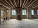 Spacious unfinished living room framing showing natural light from multiple windows and a framed fireplace at 3301 Dell Dr, Raleigh, NC 27609