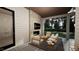 Relaxing outdoor patio with fireplace and seating area, overlooking a tranquil backyard at 3301 Dell Dr, Raleigh, NC 27609