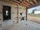 Unfinished patio featuring a fireplace and sliding glass doors to the backyard, blending indoor and outdoor living at 3301 Dell Dr, Raleigh, NC 27609