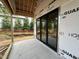 Covered patio showing the construction phase with large sliding glass doors providing a view to the back yard at 3301 Dell Dr, Raleigh, NC 27609