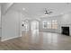 Bright living room featuring hardwood floors, modern ceiling fan, and fireplace at 359 N Maple Walk Dr # 210, Garner, NC 27529