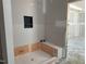 Bathroom featuring an alcove shower with bench and tiled walls, ready for your custom finishes at 2400 Adrift Rd, Fuquay Varina, NC 27526