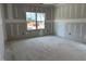 Spacious unfinished bedroom with natural light coming in from a window in a new construction home at 2400 Adrift Rd, Fuquay Varina, NC 27526