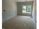 Well-lit room with one large window and neutral walls at 2400 Adrift Rd, Fuquay Varina, NC 27526
