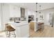 Bright kitchen features an island with seating, stainless appliances, and modern finishes at 2400 Adrift Rd, Fuquay Varina, NC 27526