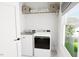 Bright laundry room featuring a washer, dryer, and overhead shelving at 2400 Adrift Rd, Fuquay Varina, NC 27526