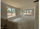 Bright living room featuring multiple large windows for ample natural light at 2400 Adrift Rd, Fuquay Varina, NC 27526
