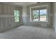 Bright living room features large windows and unfinished walls, offering a blank canvas for your design ideas at 2400 Adrift Rd, Fuquay Varina, NC 27526