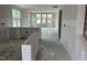 Open-concept living space with drywall, kitchen island, and bright windows at 2400 Adrift Rd, Fuquay Varina, NC 27526