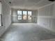 Large living room showcasing new drywall, recessed ceiling, and large windows at 2400 Adrift Rd, Fuquay Varina, NC 27526