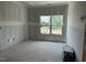 Bright room with large window and unfinished walls, awaiting your personal touch to create the perfect space at 2400 Adrift Rd, Fuquay Varina, NC 27526