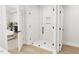 Bright shower with a glass door, white tile, and a built-in niche at 2400 Adrift Rd, Fuquay Varina, NC 27526