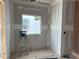 Bathroom during construction with window and tiling partially completed at 2404 Adrift Rd, Fuquay Varina, NC 27526